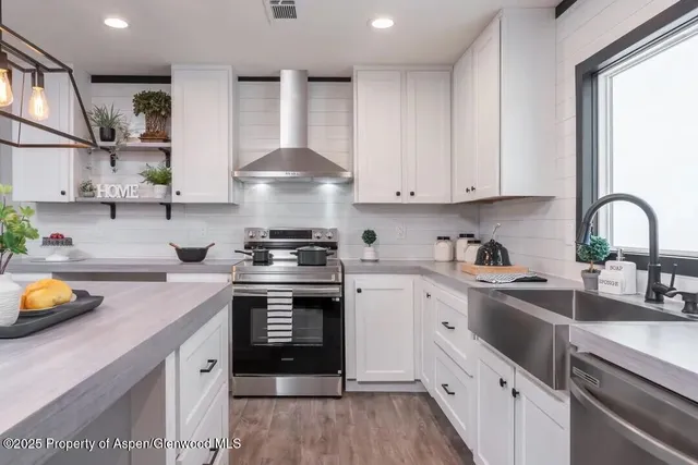 a kitchen with a sink stove and cabinets