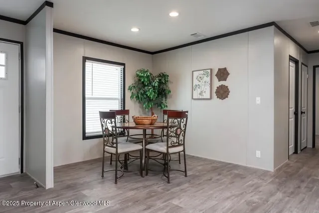 a dining room with furniture and window