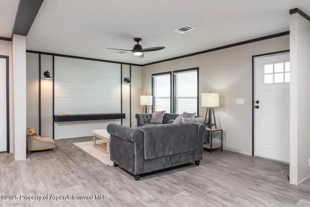 a living room with a bed furniture and a large window