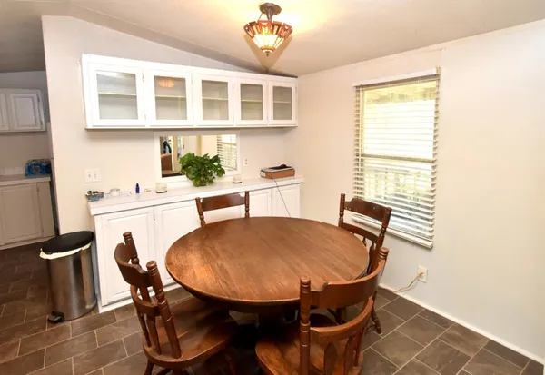 a kitchen with white cabinets and appliances