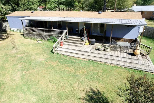 a view of house with swimming pool and sitting area