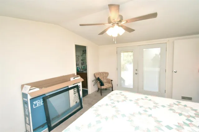 a bedroom with a bed and a painting on the wall