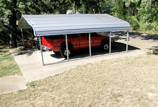 a view of a house with wooden fence