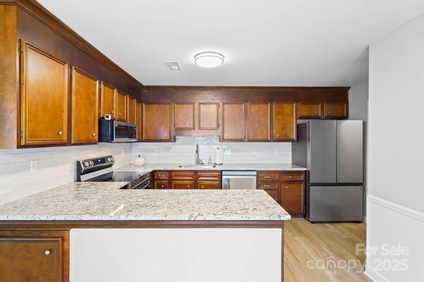 2707 Quailrush Road Charlotte, NC 28226 - Photo 11 of 29 a kitchen with granite countertop kitchen island a sink appliances and cabinets