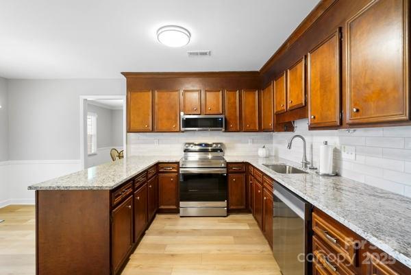 2707 Quailrush Road Charlotte, NC 28226 - Photo 12 of 29 a kitchen with stainless steel appliances granite countertop wooden cabinets a sink and a stove