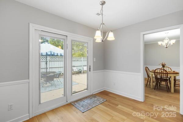 2707 Quailrush Road Charlotte, NC 28226 - Photo 13 of 29 a view of a livingroom with furniture wooden floor and a chandelier