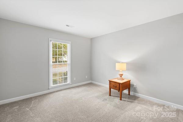 2707 Quailrush Road Charlotte, NC 28226 - Photo 23 of 29 an empty room with windows and ceiling fan