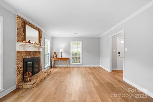 2707 Quailrush Road Charlotte, NC 28226 - Photo 7 of 29 a view of empty room with wooden floor and fireplace