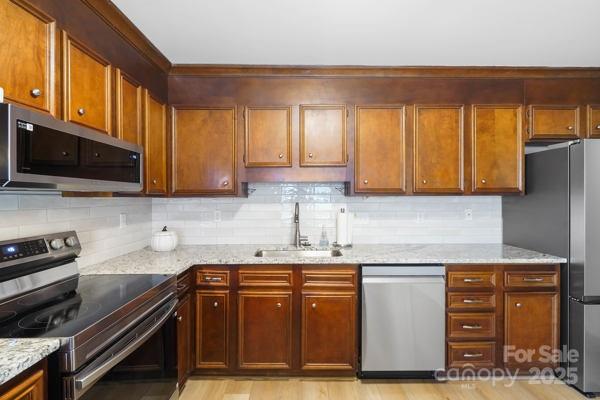 2707 Quailrush Road Charlotte, NC 28226 - Photo 10 of 29 a kitchen with stainless steel appliances granite countertop a stove a sink and a microwave