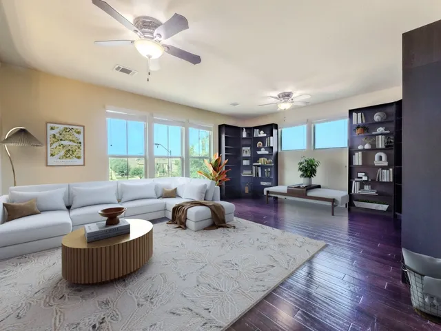 a living room with furniture and a wooden floor