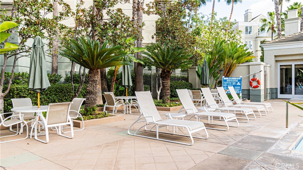 2233 Martin, Unit 300 Irvine, CA 92612 - Photo 19 of 25 a view of a patio with a dining table and chairs with a fire pit