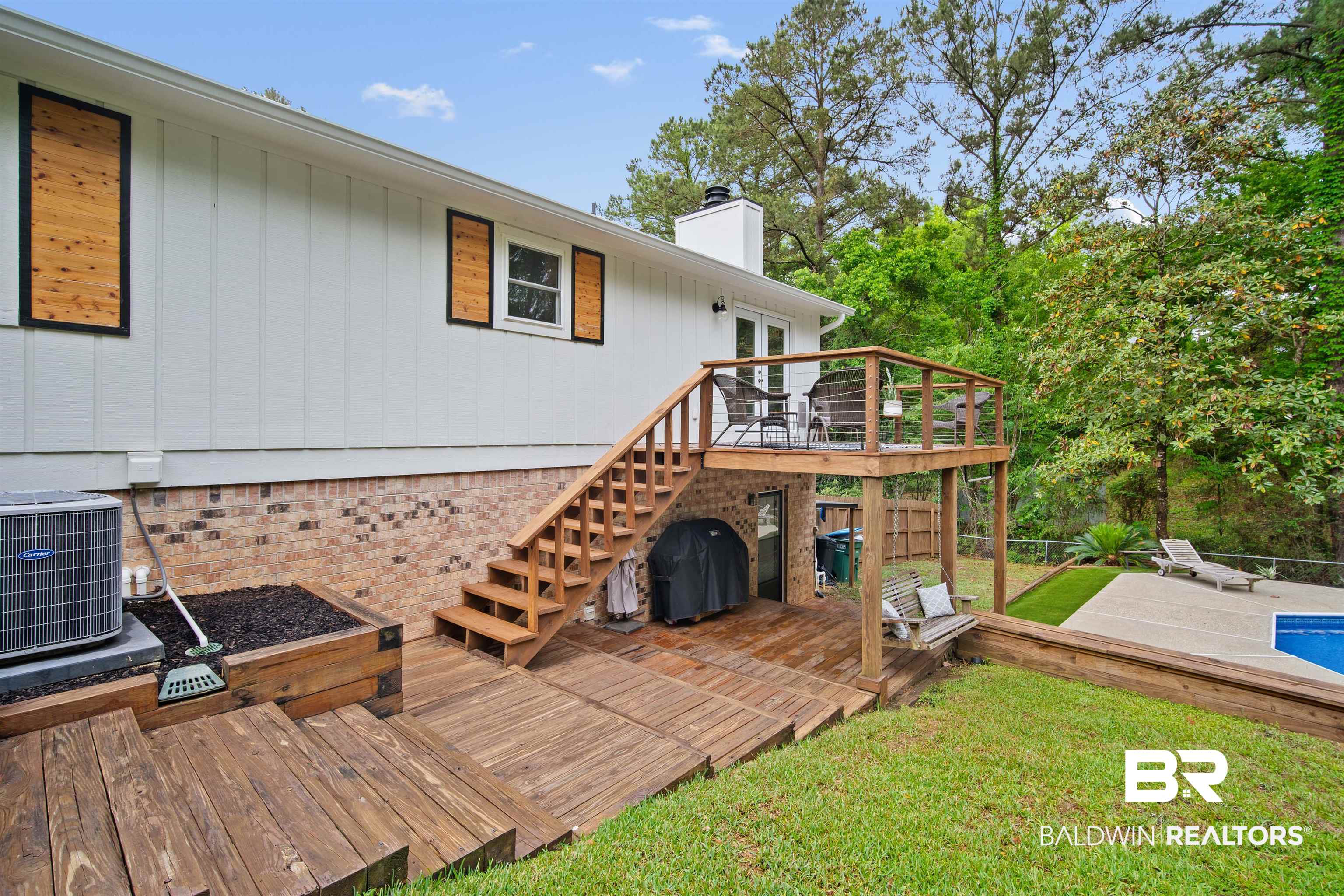 71 Caisson Trace Daphne, AL 36527 - Photo 27 of 36 Multi-level wooden deck with cable railing and an integrated staircase