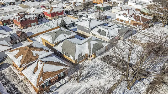 an aerial view of a house with a yard