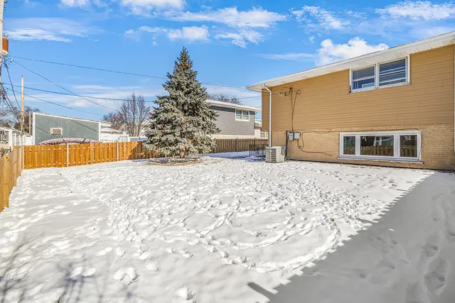a view of a house with snow on the road