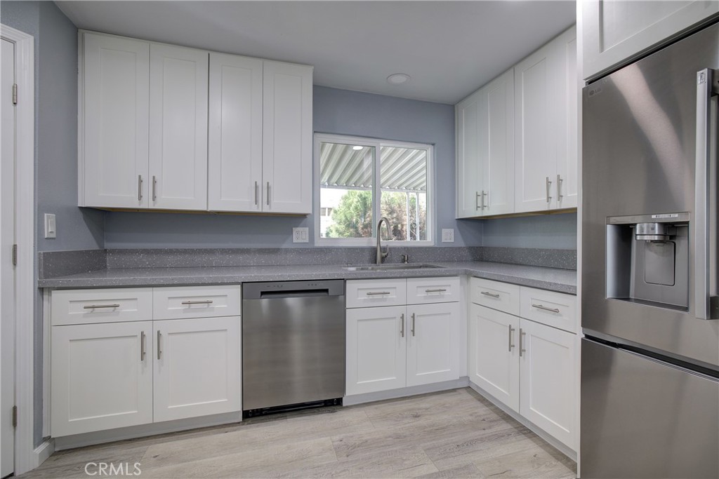 3700 Buchanan Street, Unit 131 Corona, CA 92503 - Photo 12 of 27 a kitchen with granite countertop white cabinets stainless steel appliances and a window