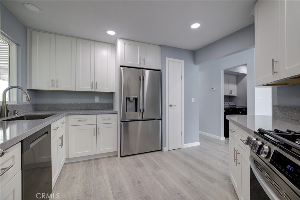 3700 Buchanan Street, Unit 131 Corona, CA 92503 - Photo 14 of 27 a kitchen with stainless steel appliances granite countertop a refrigerator a stove and a sink