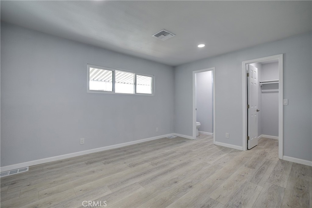 3700 Buchanan Street, Unit 131 Corona, CA 92503 - Photo 16 of 27 wooden floor in an empty room with a window
