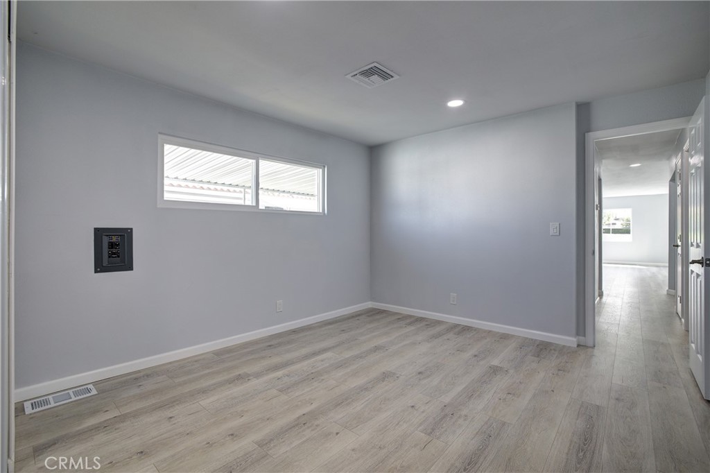 3700 Buchanan Street, Unit 131 Corona, CA 92503 - Photo 20 of 27 wooden floor in an empty room with a window