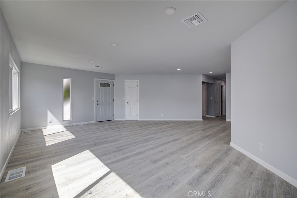 3700 Buchanan Street, Unit 131 Corona, CA 92503 - Photo 4 of 27 wooden floor in an empty room with a window