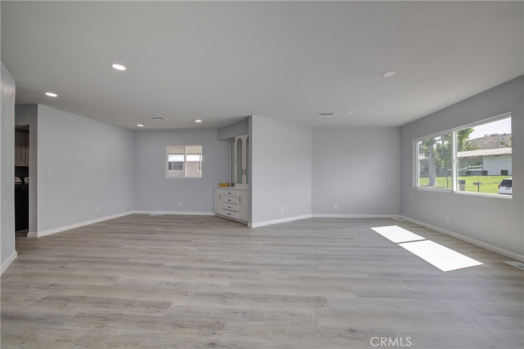 3700 Buchanan Street, Unit 131 Corona, CA 92503 - Photo 6 of 27 a view of an empty room with window and wooden floor