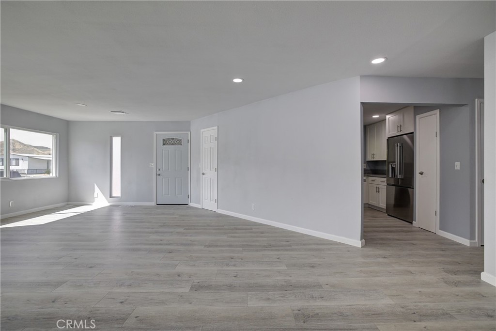 3700 Buchanan Street, Unit 131 Corona, CA 92503 - Photo 9 of 27 a view of an empty room with window and wooden floor
