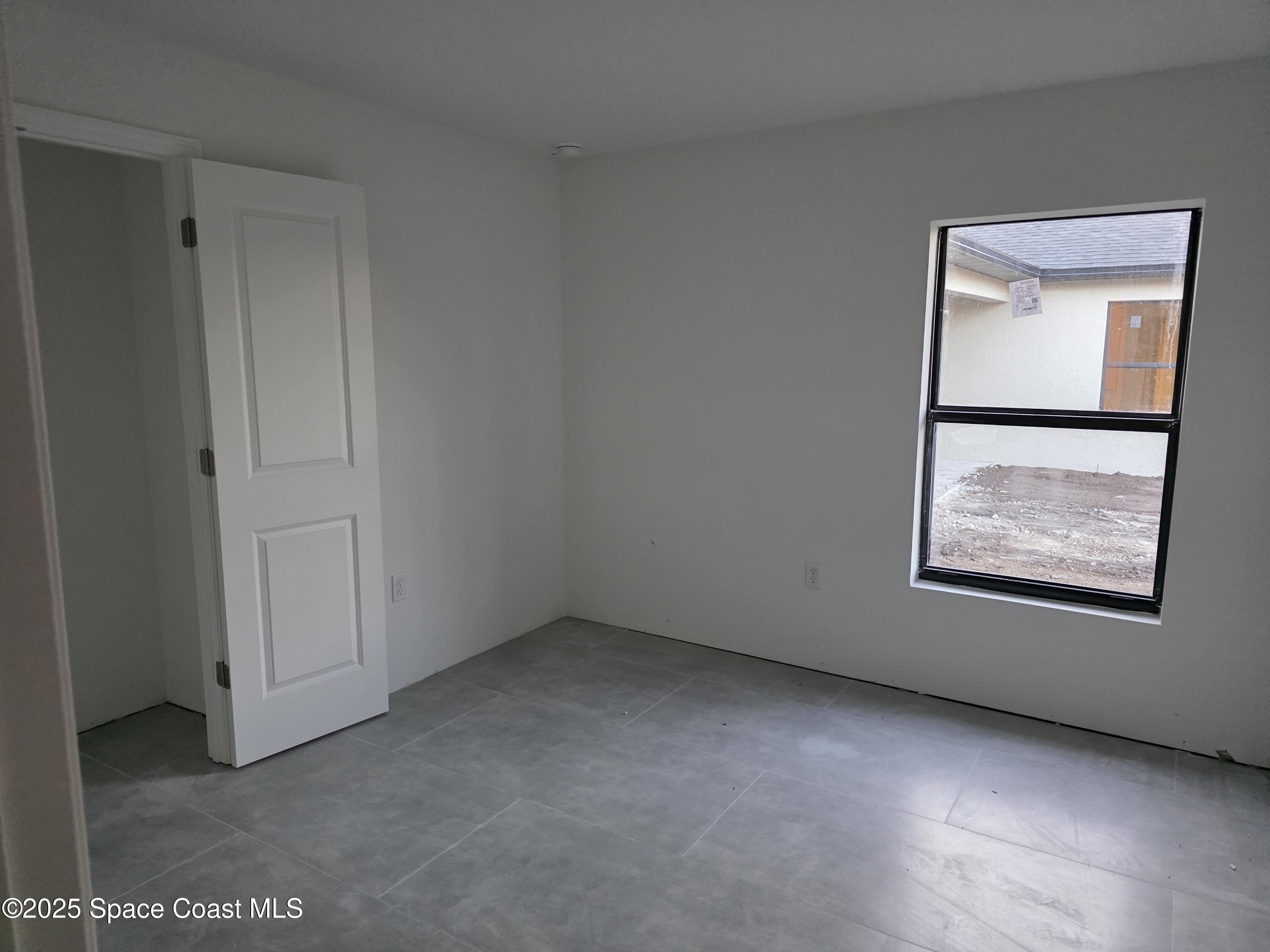 1659 Javier Street, Unit AB Palm Bay, FL 32909 - Photo 33 of 37 a view of an empty room with windows and closet