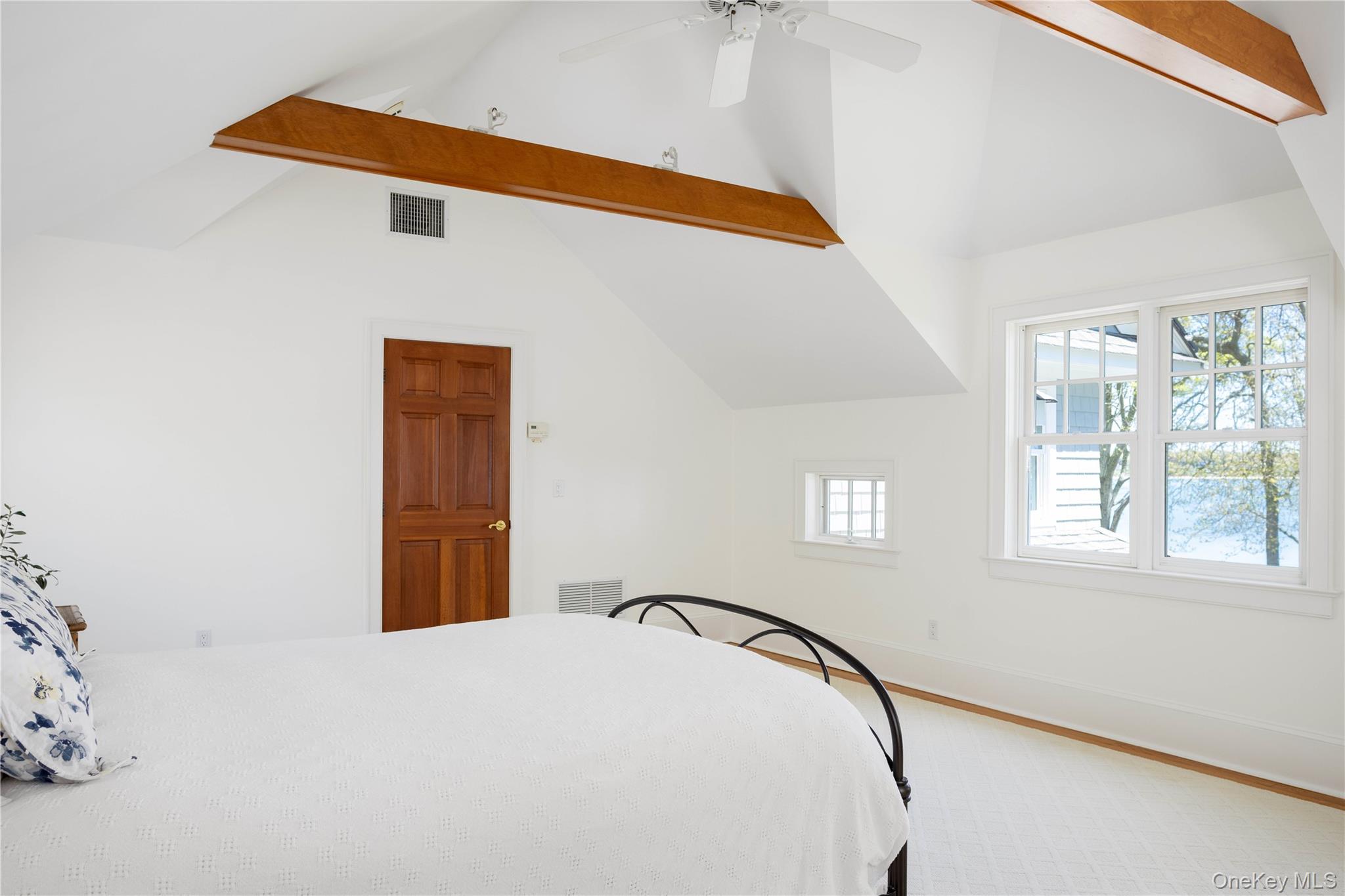 5055 New Suffolk Road New Suffolk, NY 11956 - Photo 25 of 42 a bedroom with a bed and a window