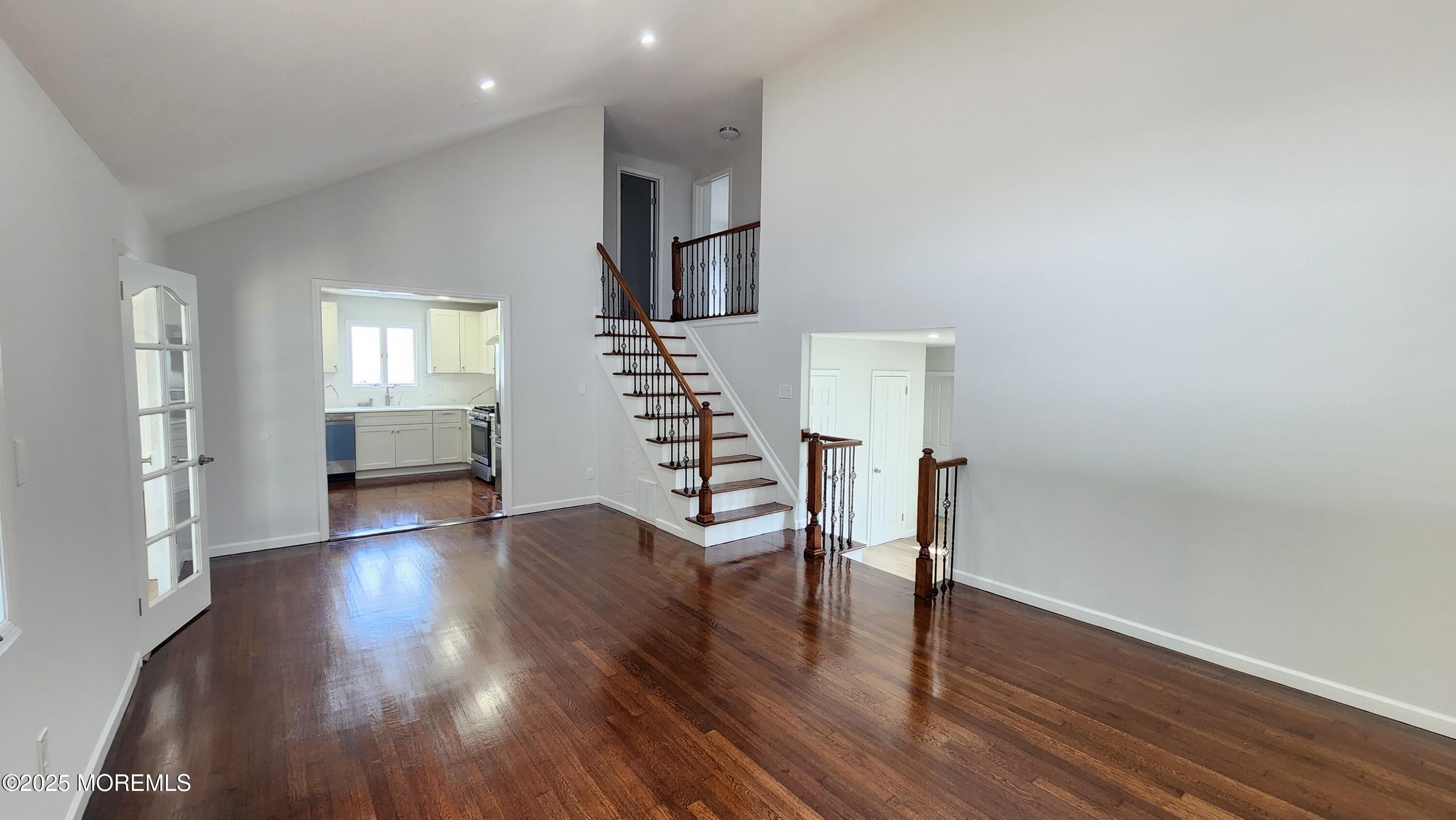 34 Hemlock Street Hazlet, NJ 07730 - Photo 13 of 30 a view of an empty room with wooden floor and stairs