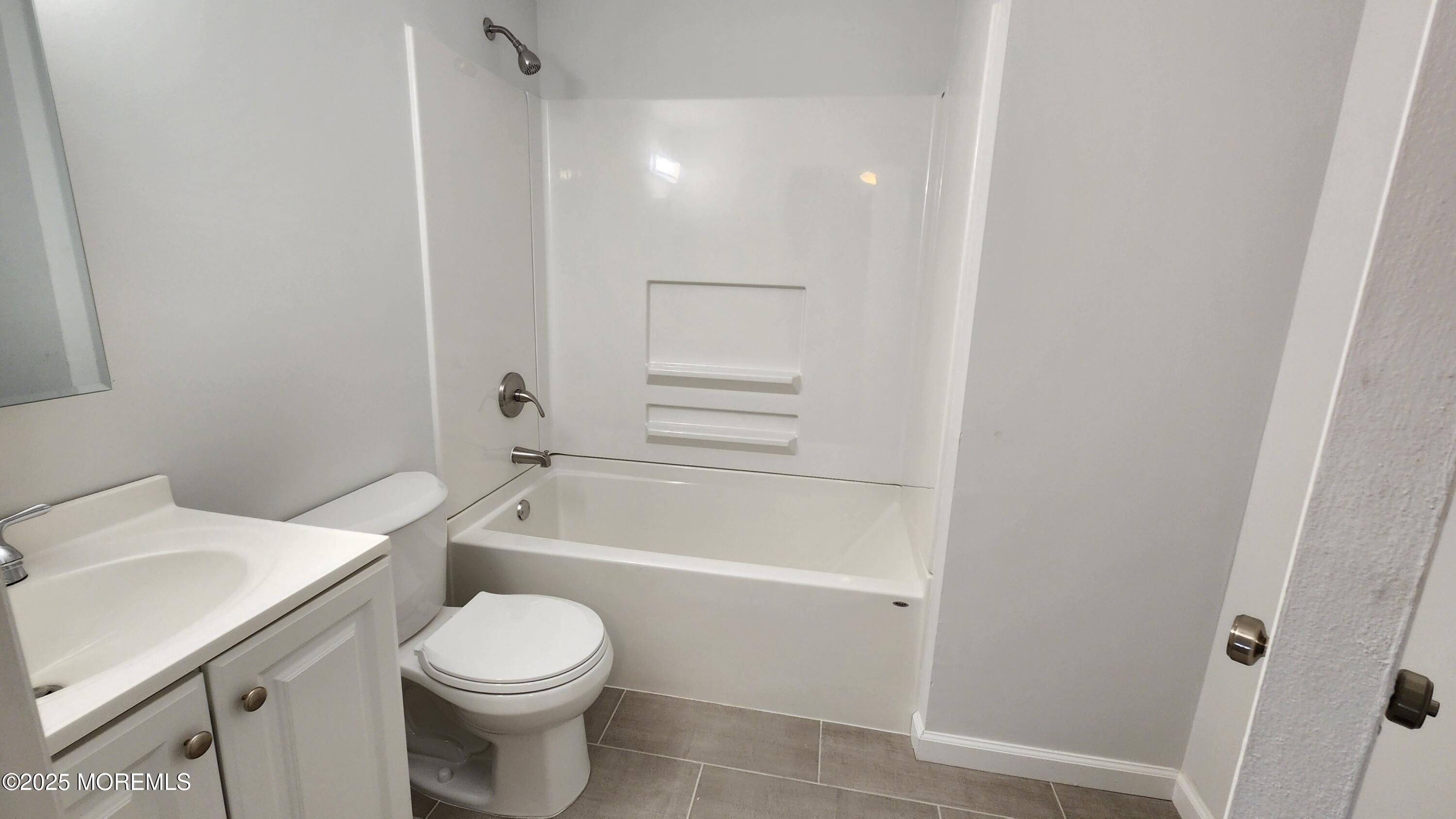 34 Hemlock Street Hazlet, NJ 07730 - Photo 16 of 30 a bathroom with a granite countertop toilet a sink and bathtub