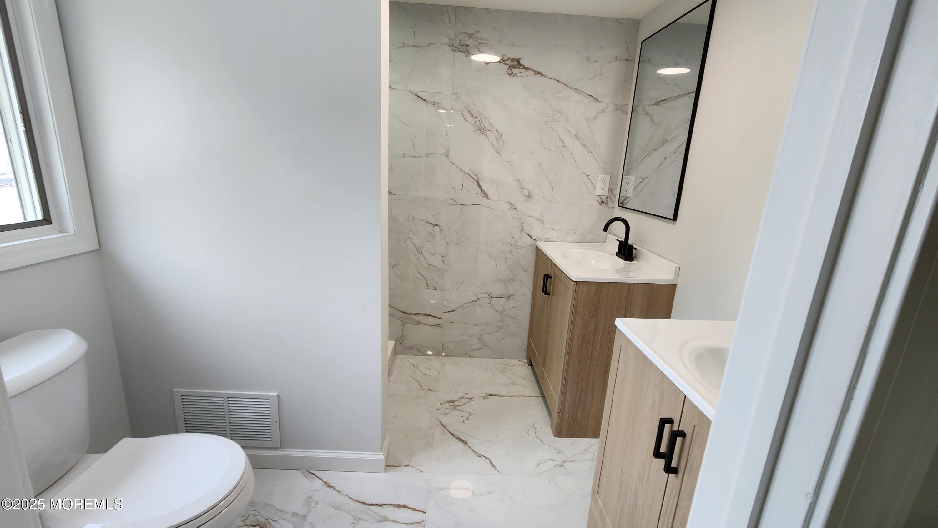 34 Hemlock Street Hazlet, NJ 07730 - Photo 18 of 30 a bathroom with a sink a toilet a mirror and shower