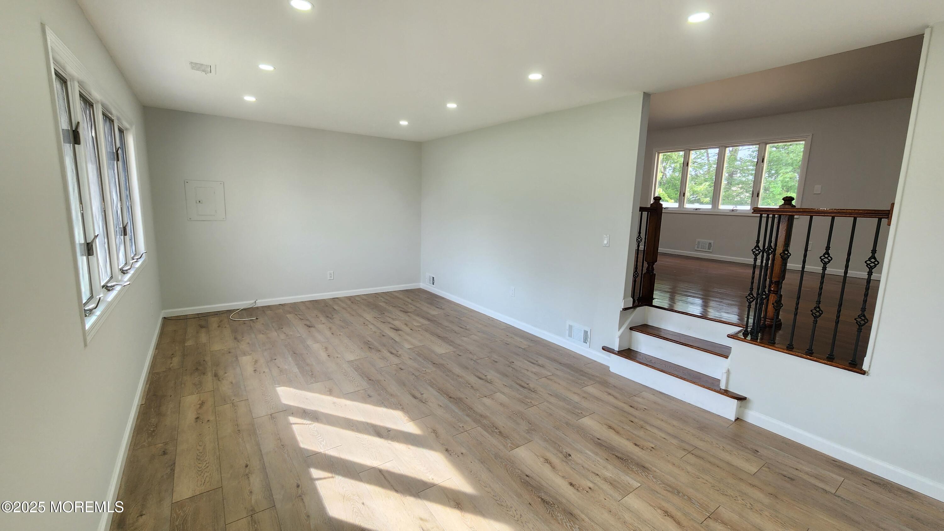 34 Hemlock Street Hazlet, NJ 07730 - Photo 2 of 30 an empty room with wooden floor and windows