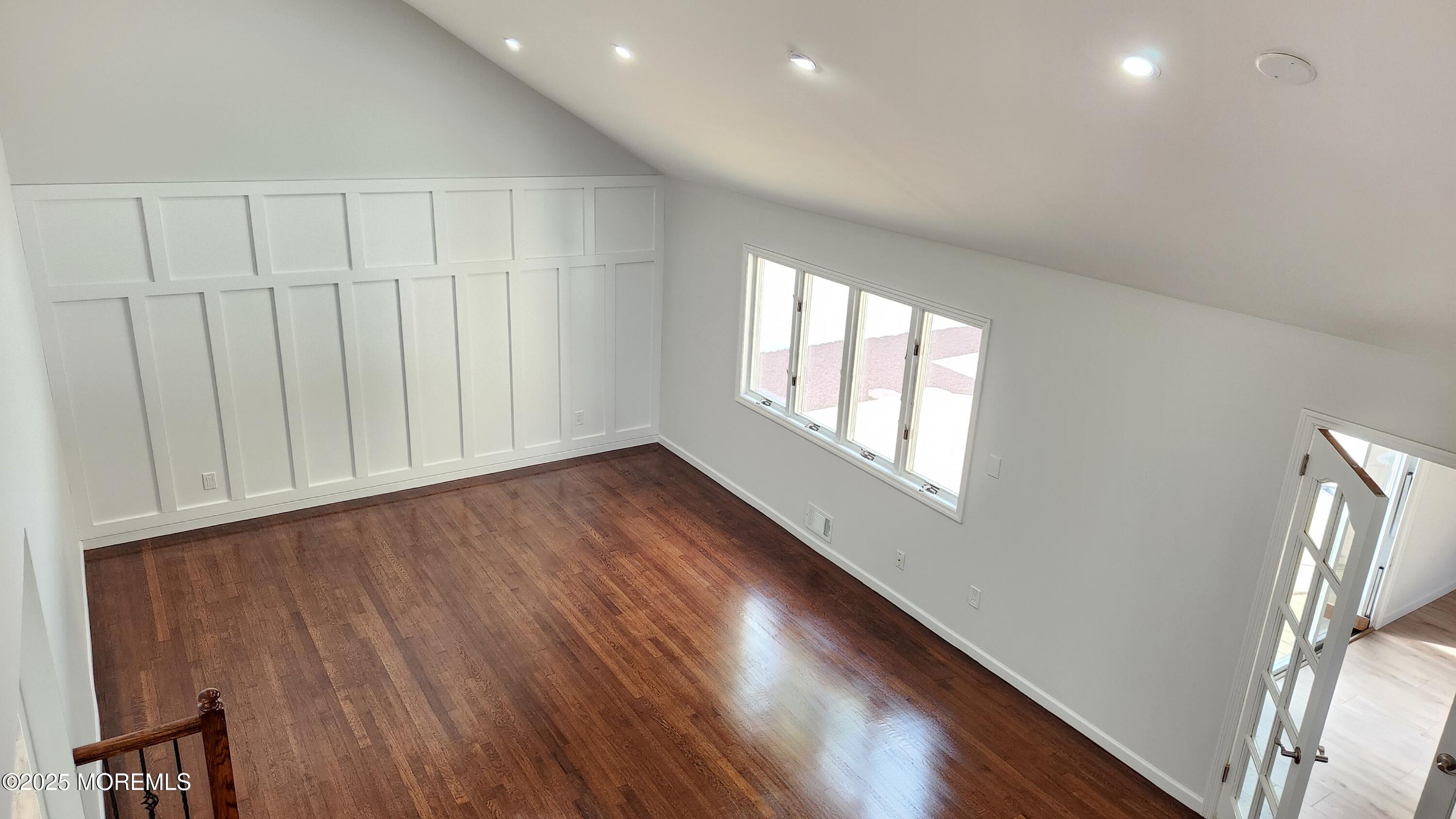 34 Hemlock Street Hazlet, NJ 07730 - Photo 21 of 30 a view of an empty room with wooden floor and a window