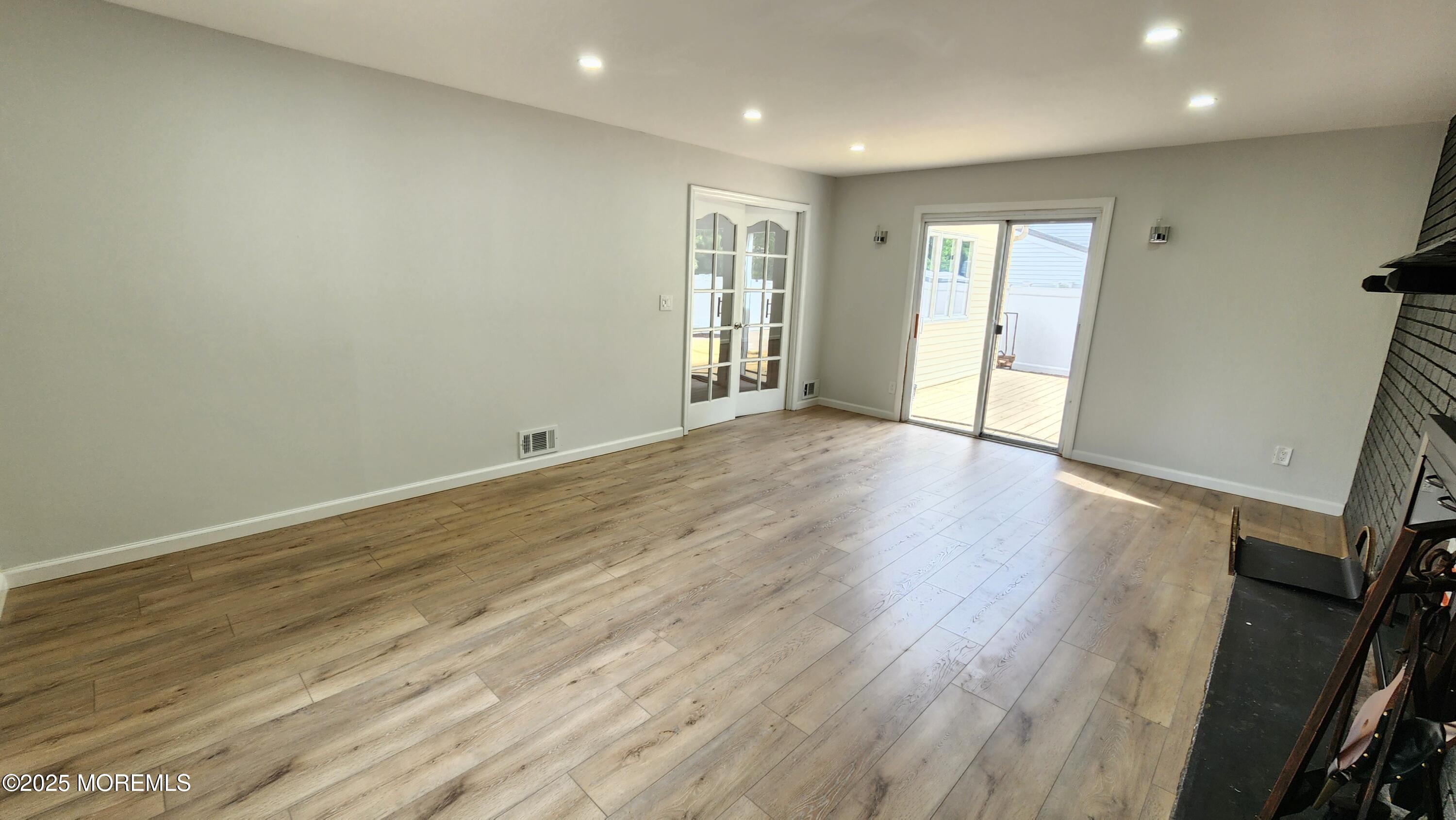 34 Hemlock Street Hazlet, NJ 07730 - Photo 23 of 30 an empty room with wooden floor and windows