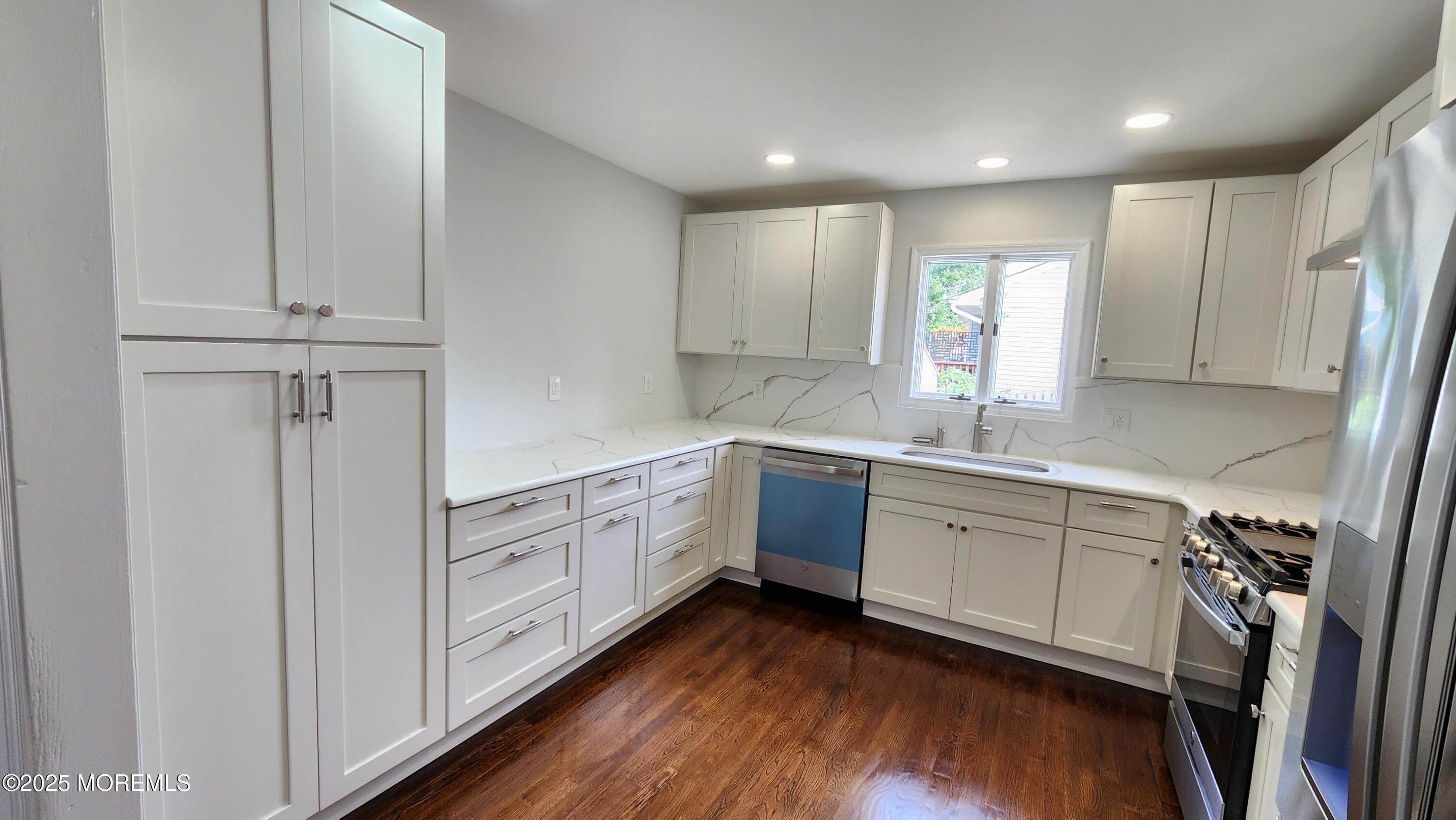 34 Hemlock Street Hazlet, NJ 07730 - Photo 5 of 30 a kitchen with cabinets a sink and appliances