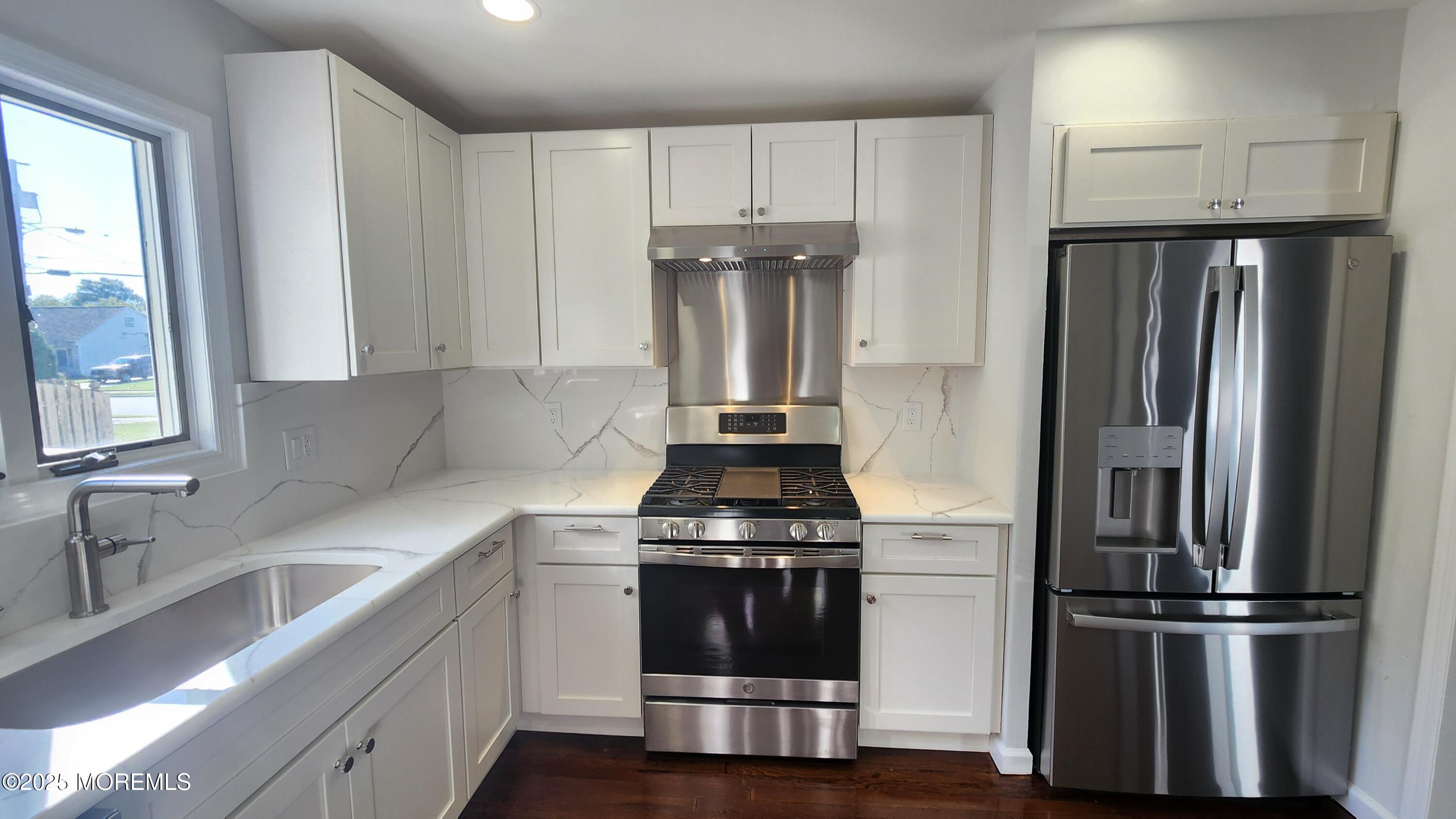 34 Hemlock Street Hazlet, NJ 07730 - Photo 7 of 30 a kitchen with a refrigerator sink and cabinets