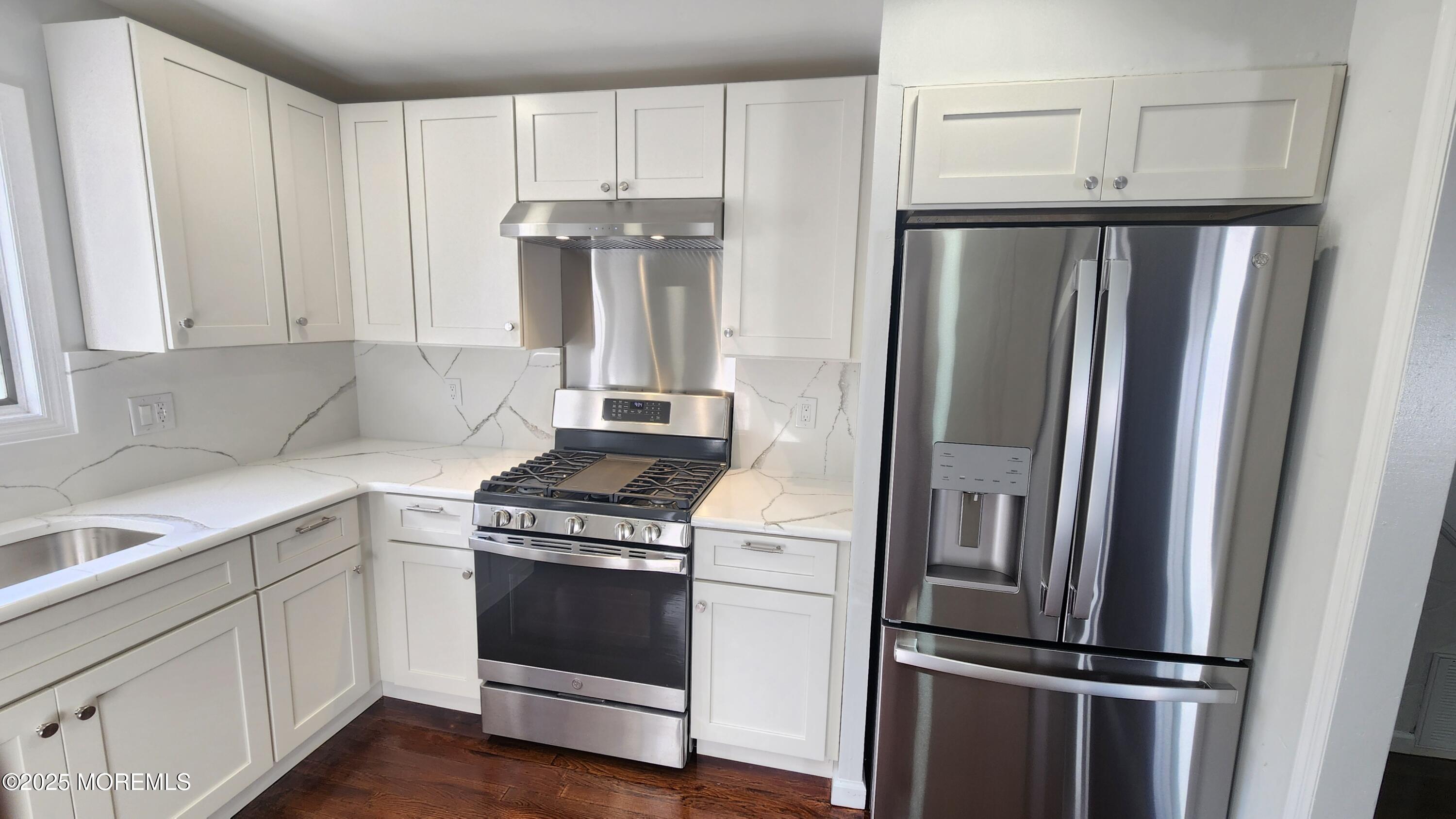 34 Hemlock Street Hazlet, NJ 07730 - Photo 8 of 30 a kitchen with a refrigerator stove and white cabinets