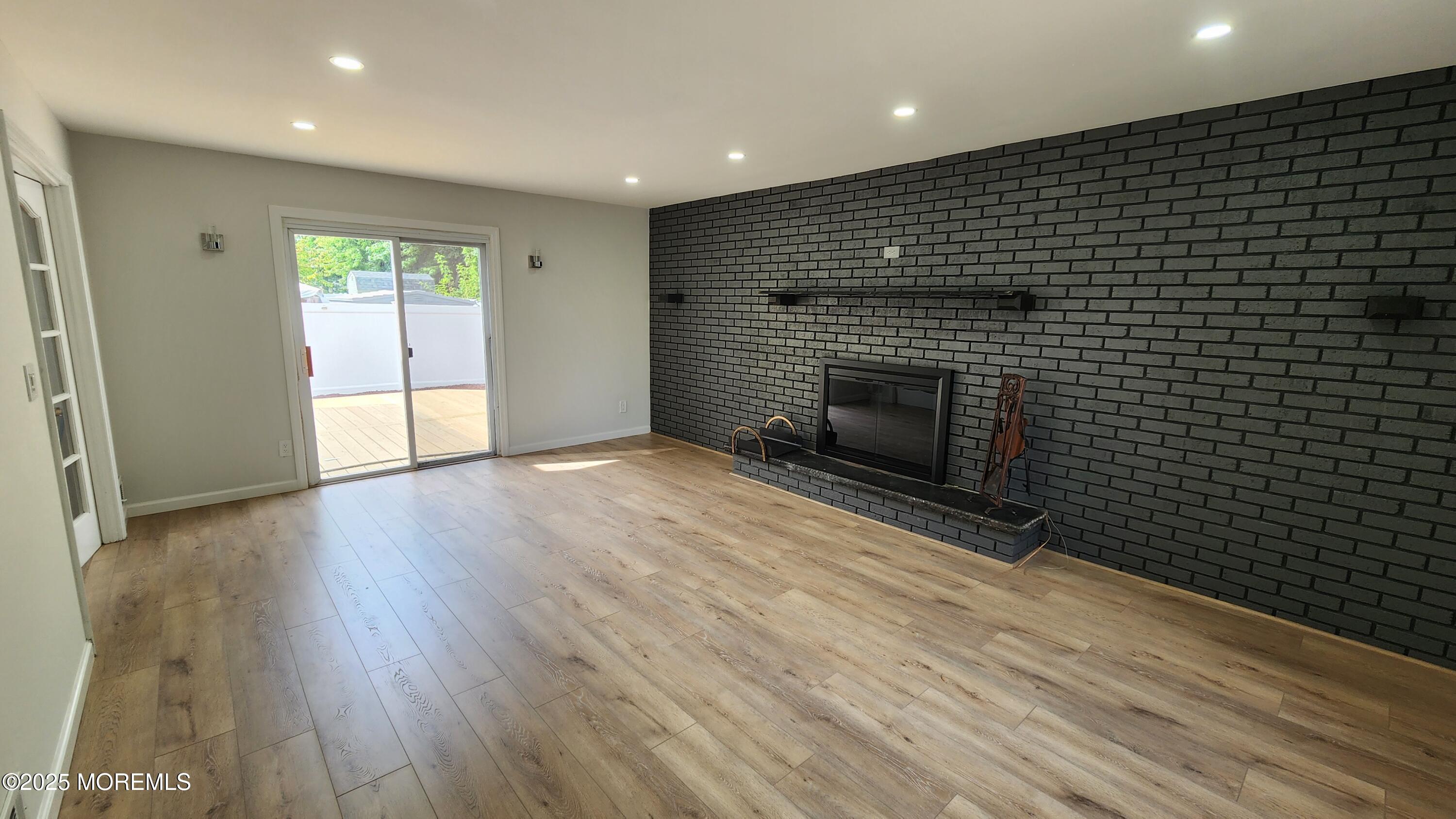 34 Hemlock Street Hazlet, NJ 07730 - Photo 10 of 30 an empty room with wooden floor fireplace and windows