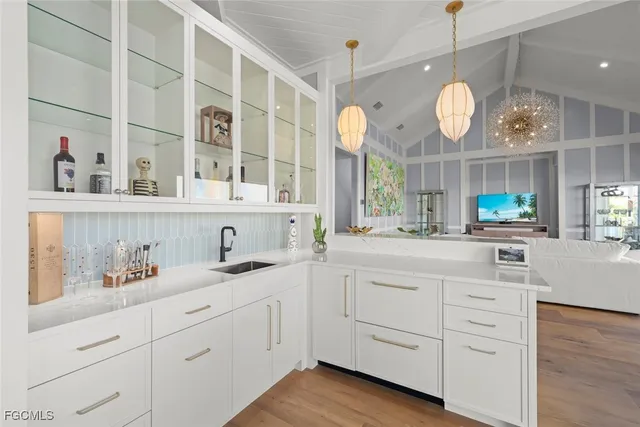 a kitchen with cabinets a window and stainless steel appliances