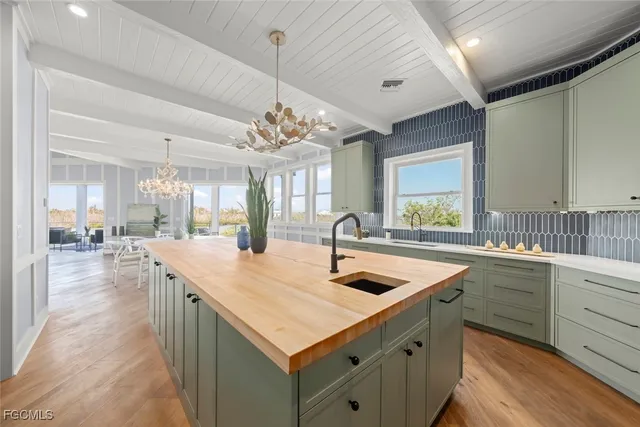 a kitchen with center island table and chairs