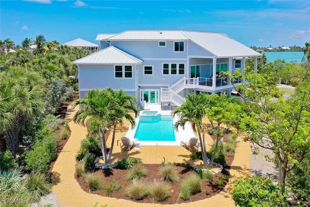 a aerial view of a house with a yard and potted plants