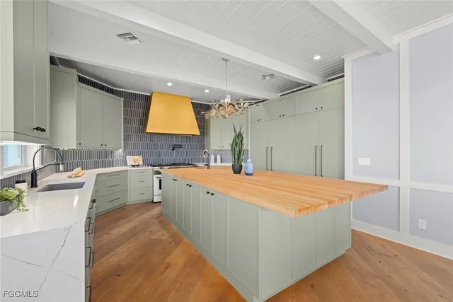 a large white kitchen with a large window