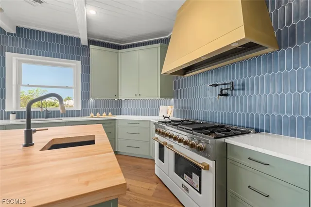 a kitchen that has a sink and a stove