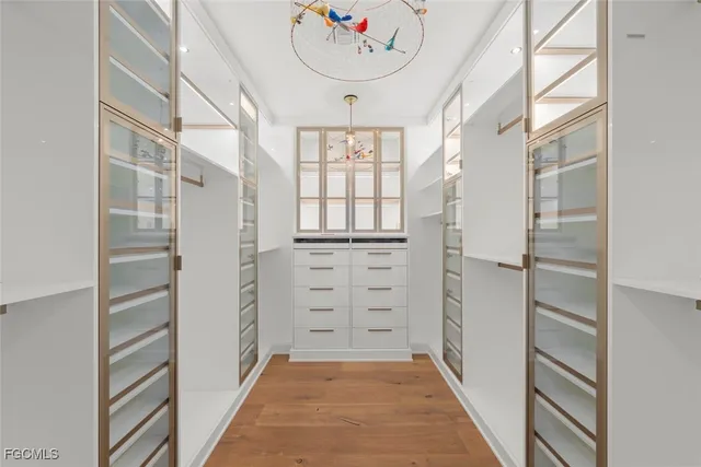 a spacious bedroom with a bed a table and chair