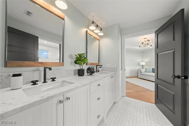 a bedroom with furniture and a chandelier