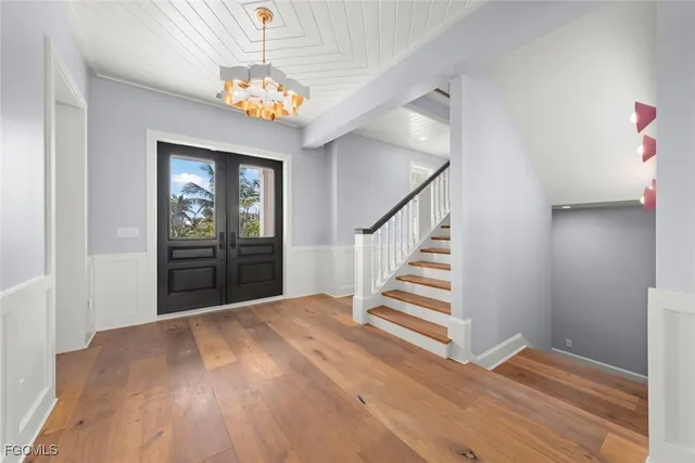 a view of entryway and hall with wooden floor