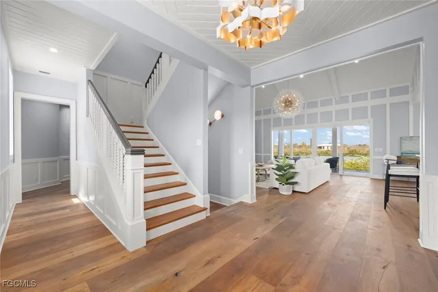 a view of a hallway view with wooden floor and staircase