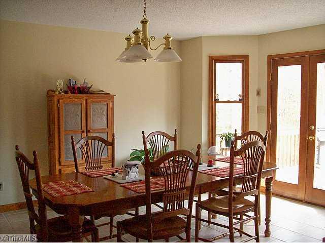 156 McDaniel Road Advance, NC 27006 - Photo 5 of 8 Dining Room. Tile floors in kitchen and dining area. Glass doors lead to spacious 23x12 rear deck.