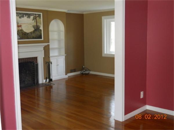 173 Abbott Street Springfield, MA 01118 - Photo 4 of 19 a view of an empty room with wooden floor and a fireplace