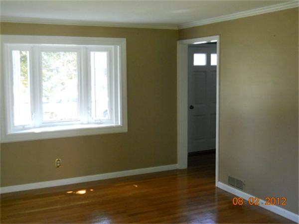 173 Abbott Street Springfield, MA 01118 - Photo 6 of 19 a view of an empty room with wooden floor and a window