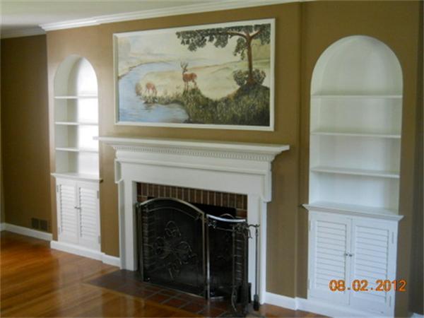 173 Abbott Street Springfield, MA 01118 - Photo 7 of 19 a living room with a fireplace and a painting on the wall